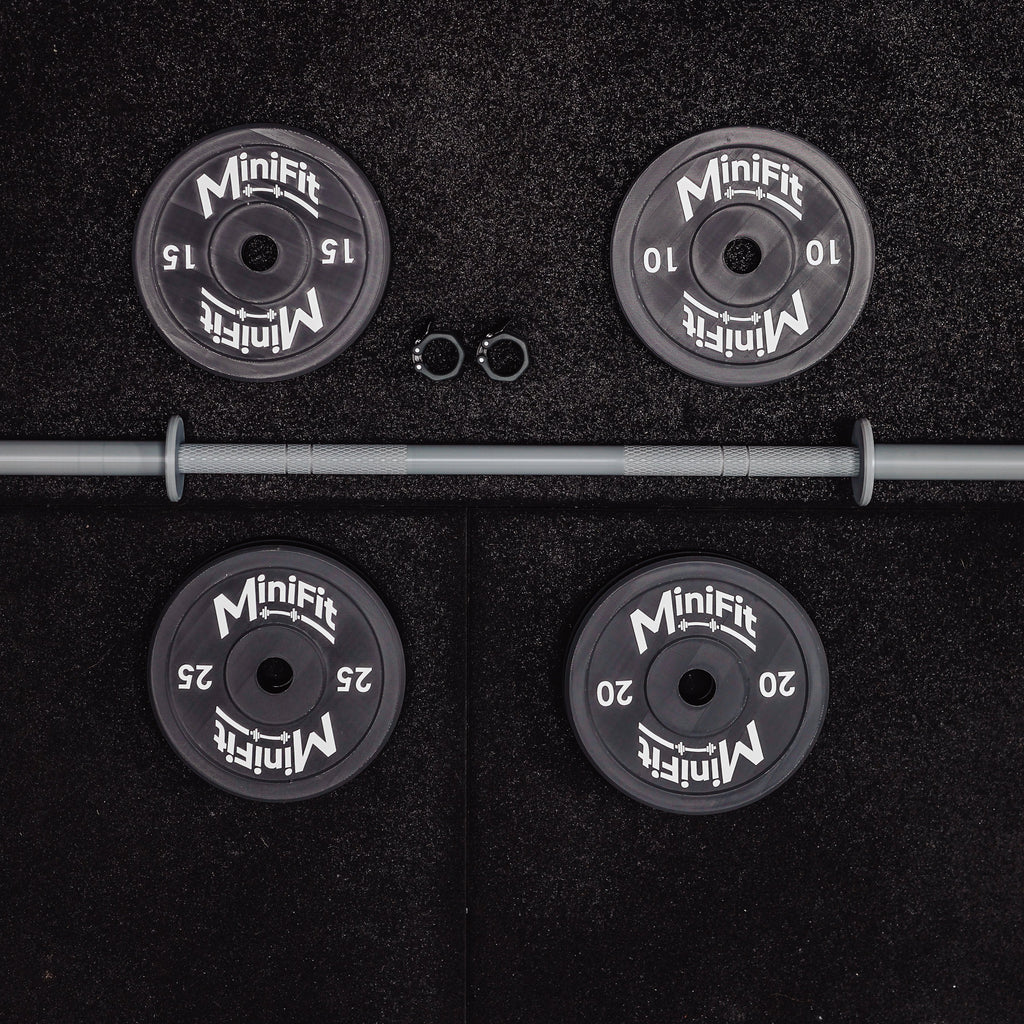 Set of child's weight plates and barbell on a black gym mats