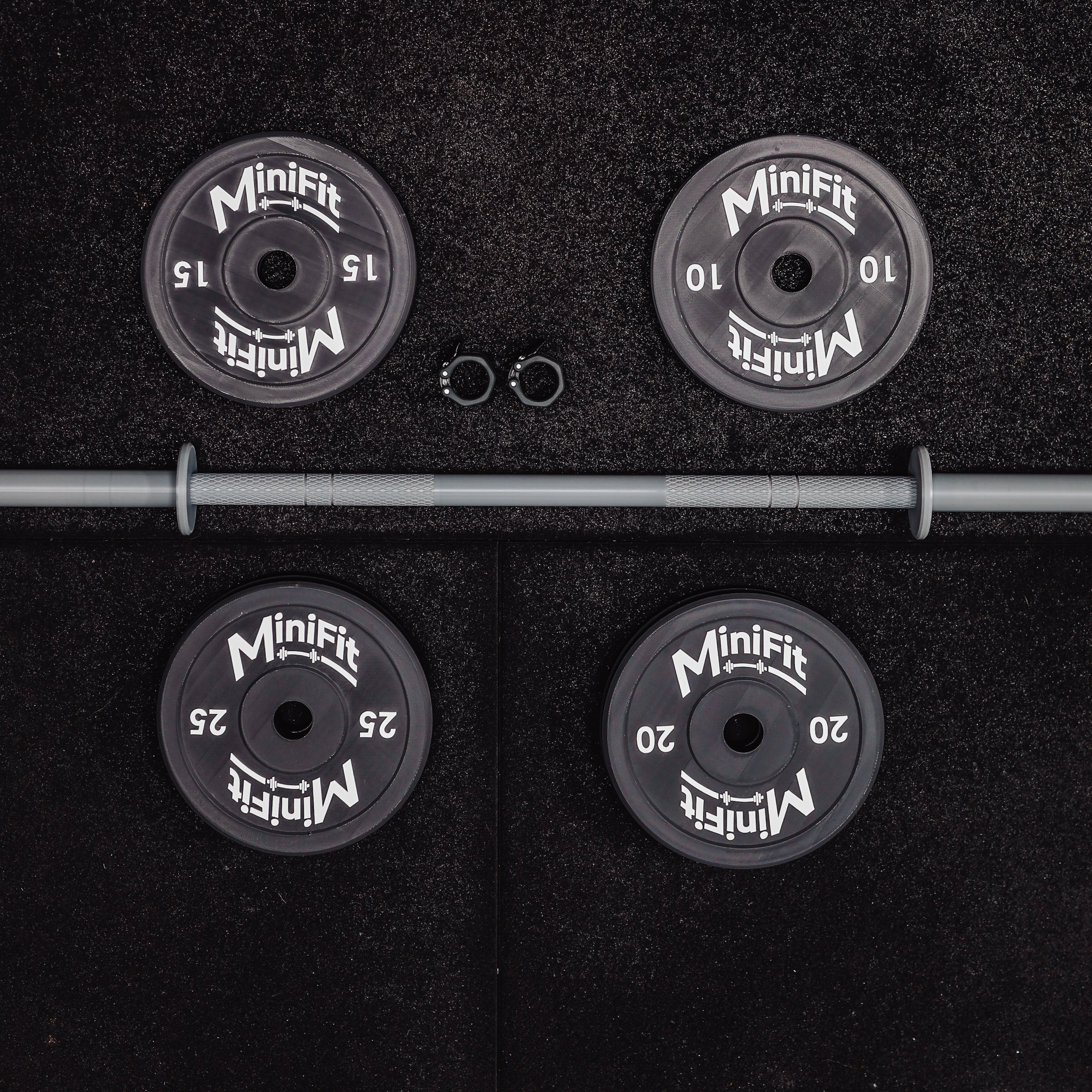 Set of child's weight plates and barbell on a black gym mats