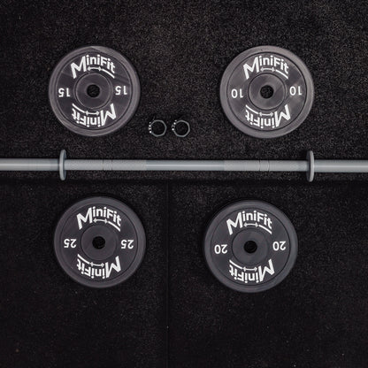 Set of child's weight plates and barbell on a black gym mats