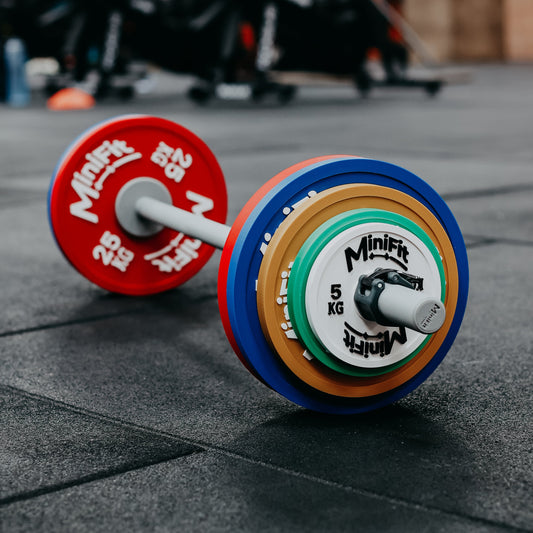 Colourful children's powerlifting barbell set on a gym floor 